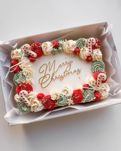 a decorated christmas cake in a box on a table