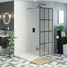 a bathroom with tiled flooring and white tiles on the walls is pictured in this image