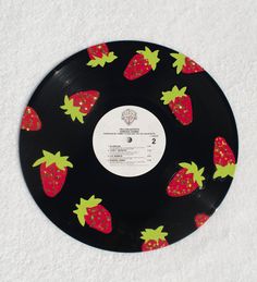 a black record with strawberries on it