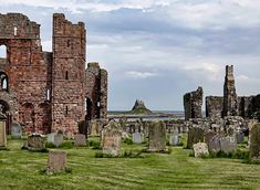 the ruins of an old castle with grass in front