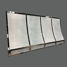 a large mirror hanging on the side of a wall