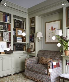 a living room filled with furniture and lots of books