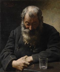 an old man sitting at a table with a glass in front of him and looking down