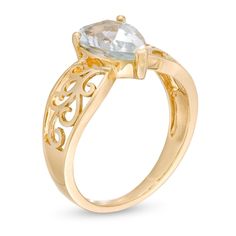 She'll be proud to wear this ravishing gemstone ring. Crafted in warm 10K gold, this unforgettable design showcases a 10.0 x 7.0mm pear-shaped icy-blue aquamarine solitaire centered on a sculpted filigree-detailed shank. Buffed to a brilliant luster, this ring is a fabulous choice she won't be able to resist. Fine Jewelry Yellow Gold Topaz Ring With Teardrop, Fine Jewelry Yellow Gold Topaz Teardrop Ring, Elegant Yellow Gold Pear-shaped Topaz Ring, Elegant Pear-shaped Yellow Gold Topaz Ring, Teardrop Topaz Ring In Yellow Gold For Wedding, Yellow Gold Teardrop Topaz Ring For Wedding, Yellow Gold Teardrop Topaz Wedding Ring, Fine Jewelry Pear-shaped Topaz Ring For Anniversary, Pear-shaped Topaz Ring For Anniversary, Fine Jewelry