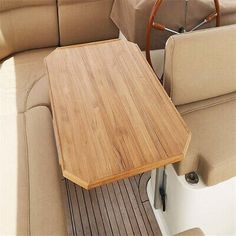 a wooden table sitting on top of a boat next to a motorboat's cockpit