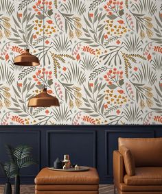 a living room with two leather chairs and a wallpapered pattern on the wall