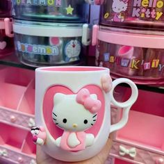 a hello kitty coffee mug with a pink bow on it's handle in a store