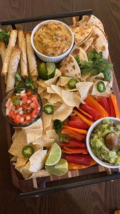 a platter filled with tortillas, guacamole and salsa