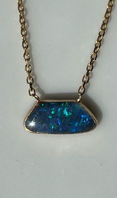 "At the center of this gorgeous necklace is an irregular shape opal14K encased in 14K gold and set onto a 14K gold chain. The free form opal stone is about 13mm at its widest and is about 4mm long. The chain is 16\" long. The lobster claw closure is marked 14K. This lovely piece is in beautiful estate condition. Please see all photos for details and condition. Thank you for looking!" Fine Jewelry Opal Cabochon Necklace, Oval Opal Necklace With Polished Finish, Unique Opal Necklaces For Formal Occasions, Unique Oval Opal Necklaces, Unique Yellow Gold Opal Necklaces, Unique Yellow Gold Opal Necklace, Boulder Opal Necklace, Gold Link Bracelet, Opal Stone