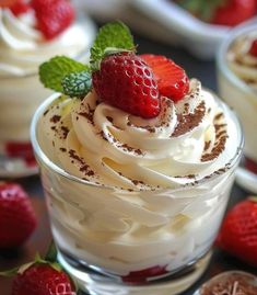 two desserts with whipped cream and strawberries on top