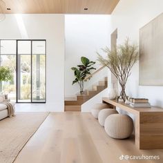 a living room filled with furniture and a staircase