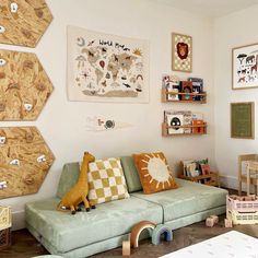 a living room filled with furniture and lots of pictures on the wall above it's couch