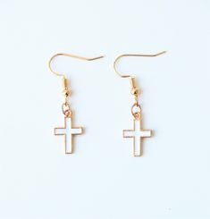 Cross Charm Earrings White, Gold White Cross Earrings, Daily Uses Earrings Material: LEAD and NICKEL FREE zinc alloy Feel free to message me if you have any questions and we will get back to you as soon as possible Remove before showering, swimming, and sleeping. Due to natural differences you will see slight variations from one piece to another however this only increases their originality and sentiment. Standard Shipping Times: 5-12 Business Days Canada - orders are shipped standard letter mai Single White Metal Earring, Hypoallergenic White Metal Earrings, Nickel-free White Plug Earrings As Gift, Nickel-free White Plug Earrings For Gift, White Metal Dangle Plug Earrings, White Metal Earrings For Gift, White Metal Drop Plug Earrings, Nickel-free White Cross Jewelry, White Metal Plug Earrings With Ear Wire