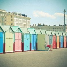 a row of colorful beach huts sitting next to each other