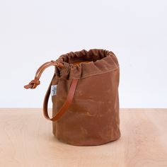 a brown bag sitting on top of a wooden table