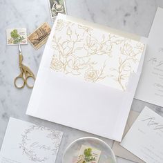 the wedding stationery is laid out and ready to be put into their guests'envelopes