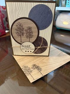 a card that has been made with wood and is sitting on top of a table