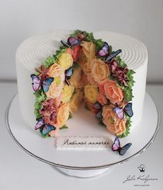 there is a cake decorated with flowers and butterflies