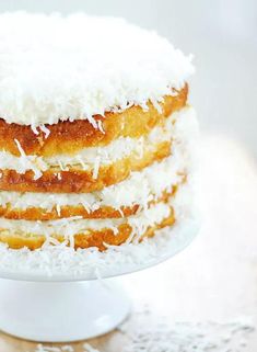 a three layer cake with coconut on top