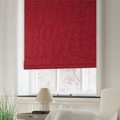 a red roman blind in a white living room