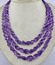 PRODUCT DETAILS LINE 3/CTS 585 NATURAL AMETHYST TUMBLE BEADS   ALL NATURAL COLOR NATURAL BEADS SIZES OF THE BEADS ARE FROM 17 MM TO 10 MM  NECK LENGTH OF THE NECKLACE IS 16 INCHES OUTER LENGTH OF THE NECKLACE IS 18 INCHES  FINE QUALITY & BEST COLOR ATTACHED TO SIZABLE SILK CORD BEST LOWEST PRICE OFFERED NOTE - #You will receive the same product you see in picture. #DEAR BUYERS PLEASE FEEL FREE TO ASK QUESTIONS  #WE WILL BE GLAD TO ANSWER & SOLVE QUERY REGARDING THIS PRODUCTS #RETURN POLICY Every Amethyst Tumbled, Round Bead Necklace, Best Color, Silk Cord, Amethyst Beads, Multi Strand Necklace, Rock Crystal, Beads Necklace, Natural Beads