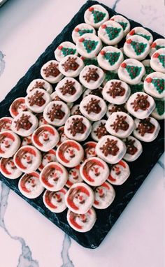 a tray filled with cupcakes covered in frosting