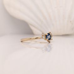 This simple and sleek blue sapphire ring is made for the minimalist in your life! With asymmetrical diamond accents around a blue sapphire, this piece is subtle and classy. Its sturdy band allows for everyday, worry-free wear. This ring can be a beautiful September birthstone gift for your loved ones! This ring is made with solid 14K Gold and naturally Earth-mined SI / G-H diamonds. As listed, this ring is ready to ship. If you're interested in purchasing this setting with a different center sto Fine Jewelry 14k Gold Sapphire Ring With Accent Stones, Dainty Yellow Gold Sapphire Ring With Accent Stones, Sapphire Rings With Gemstone Accents, Round Cut, Delicate 14k Gold Sapphire Ring, Gold Sapphire Ring With Accent Stones, Perfect Gift, Designer Silver Jewellery, Blue Sapphire Ring, Jewelry Showcases, Ring With Diamond