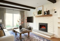 a living room filled with furniture and a fire place in the middle of a wall