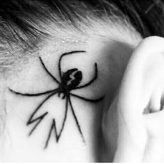 a spider tattoo on the ear