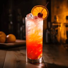 an orange and red drink sitting on top of a wooden table