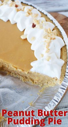 a piece of peanut butter pudding pie with whipped cream on top and pecans in the background