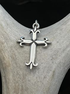 Retired James Avery Sterling Silver Fleuree Large Cross Pendant with Bale.  It is an early piece, but I don't have an exact date for it.  It is fully hallmarked on the back.  This beautiful pendant  by James Avery is perfect for the collector or as a special and meaningful gift, whether it be a going away present, for Christmas, Easter or birthday gift.  Made in the United States with 925 sterling silver athis pendant is sure to be a cherished piece for years to come.   MATERIAL: Sterling Silver COLOR: Silver with black oxidation STAMP: Candelabra with JA on either side, "STER" underneath.  Copyright mark MEASUREMENTS:  1 1/8" Across 1 3/4" Length, Bale 1/4" round WEIGHT: 7.5 grams CONDITION: Very good pre-owned condition, minor surface wear & patina. Please refer to picture for additional Present For Christmas, Boulder Co, James Avery, Meaningful Gifts, Cross Pendant, Collectable Items, Silver Color, Favorite Jewelry, Jewelry Necklace Pendant