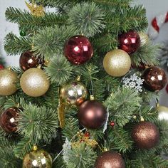 a small christmas tree with gold and red ornaments