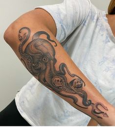 an octopus and skull tattoo on the arm