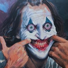 a painting of the joker holding his hand up to his face and pointing at it