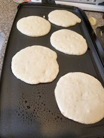 four uncooked tortillas on a baking tray ready to go into the oven