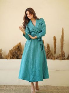 100% LINEN - LINEN WRAP DRESS WITH SHAWL COLLARS, FULL SLEEVES, Waist Tie & Concealed Pockets. Drape yourself in the tranquil, breezy elegance of our Teal Blue Linen Wrap Dress. Inspired by European sophistication, this long, linen maxi dress exudes a luxurious aura with its kimono-style robe silhouette. The shawl collars add a graceful touch, while the full sleeves and waist tie cinches your figure for a flattering ensemble that transitions effortlessly from breezy daywear to chic evening attir Blue Linen Long Sleeve Maxi Dress, Formal Long Sleeve Linen Dress, Blue Linen Long Sleeve Dress, Blue Long Sleeve Linen Dress, Blue Linen Long Sleeve Midi Dress, Blue Long Sleeve Linen Midi Dress, Elegant Long Sleeve Blue Linen Dress, Elegant Blue Long Sleeve Linen Dress, Linen Wrap Dress