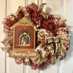 a christmas wreath with a nativity scene on it