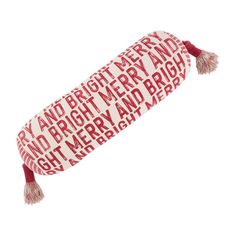 a red and white tube with words on it that are written in different languages, along with tassels