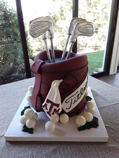 a cake made to look like a golf bag with clubs and balls in it on a table