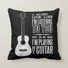 a black and white guitar pillow that says i might look like i'm listening to you