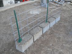 concrete blocks are placed in the middle of a construction site with wire fencing around them