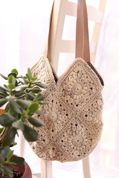 This lovely crocheted bag will be a perfect addition to any outfit with its neutral tones and simple gray blue lining. It is 13" deep by 13" wide.  Perfect as a tote, purse, or book bag! Beige Granny Square Shoulder Bag For Everyday, Everyday Beige Shoulder Bag With Granny Square, Beige Granny Square Crochet Tote Bag, Beige Granny Square Bag For Everyday Use, Natural Bag With Granny Square For Everyday Use, Natural Shoulder Bag With Granny Square, Natural Shoulder Bag With Granny Square For Everyday, Beige Crochet Eco-friendly Shoulder Bag, Beige Crochet Bag For Everyday