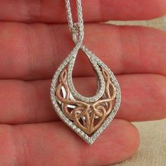 "Sterling Silver & 10K Celtic Knot & CZs Pendant Keith Jack's Love's Chalice Pendant: 3/4\" wide x 1 1/2\" long Bark textured Celtic Knot with Heart Trimmed with CZs Sterling Silver 18\" chain with lobster clasp. Signed by the Artist. Nicely Gift Boxed with silver cloth. Love's Chalice: Many legends speak of a chalice that never runs dry. Allow your heart to be such a cup, brimming with infinite love. Imported from Canada In Stock! Ships Immediately. This pendant comes standard with an 1 Cubic Zirconia Rose Gold Necklace For Anniversary, Rose Gold Hallmarked Diamond Necklace For Anniversary, Anniversary Rose Gold Diamond Necklace Hallmarked, Teardrop Pave Jewelry As A Gift, Teardrop Pave Setting Jewelry Gift, Teardrop Jewelry With Pave Setting As Gift, Teardrop Pendant With Pave Setting For Anniversary, Anniversary Teardrop Pendant With Pave Setting, Rose Gold Necklace With Pave Setting For Gift