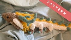 a crocheted stuffed animal laying on top of a bed