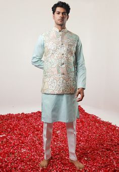 Cotton Silk Kurta in Pastel Blue. This Readymade Chinese Collar Neck and Full Sleeve attire is Enhanced with Fancy Buttons, Digital Print, Zari and Dori Work Available with a Cotton Silk Aligarhi Pant in White and an Art Silk Nehru Jacket in Pastel Blue Do note: Footwear shown in the image is for presentation purposes only. Half to one inch may vary in measurement. (Slight variation in actual color vs. image is possible) We sell all kinds of menswear. Mens Kurta | Mens Kurta Pajama | Mens Sherwa Elegant Blue Floral Print Kurta, Festive Sleeveless Blue Kurta, Blue Sleeveless Kurta For Festive Occasions, Festive Blue Sleeveless Kurta, Traditional Sleeveless Blue Kurta, Blue Cotton Nehru Jacket For Wedding, Blue Embroidered Cotton Nehru Jacket, Blue Cotton Nehru Jacket For Festive Occasions, Festive Blue Cotton Nehru Jacket