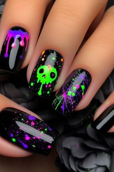 Add a vibrant touch to your Halloween look with these black nails featuring neon green and purple accents. This eye-catching design combines classic black polish with bold neon highlights for a fun and festive manicure. Perfect for celebrating the season with a pop of color with minimal effort. Glowing Halloween Nails, Gel Polish Halloween Nails, Vibrant Halloween Nails, Purple Black And Green Nails, Monster Truck Nail Designs, Halloween Nail Designs Glow In The Dark, Black Bright Nails, Black And Neon Halloween Nails, Halloween Nails Witch Theme