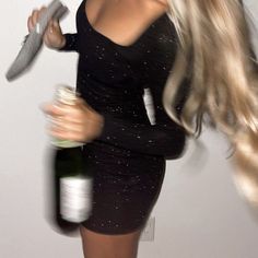 a woman with long blonde hair is holding a bottle and a knife in her hand