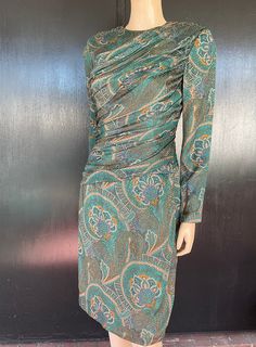 "1980s Carolyne Roehm dress. Sold at Elizabeth Arden salon. Green, gold, plum and black paisley like pattern silk. Front and back gathered on bias. Wrap type skirt. Nylon side zip goes up behind shoulder ending at top of shoulder. Six self covered button and loop fasteners on shoulder. Sleeves have two button/loop fasteners at wrist. Lined in solid green silk. Size 8 Measurements are  34\" bust 26\" waist  36\" hips 19\" bodice length  40\" length 24\" sleeves 15\" back shoulders (between sleeve Fitted Silk Dress With Paisley Print, Fitted Paisley Print Evening Dresses, Fitted Evening Dress With Paisley Print, Carolyne Roehm, Hollywood Dress, Lane Bryant Dresses, Solid Green, Fredericks Of Hollywood, Hawaiian Dress