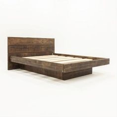 a bed frame made out of wood with no headboard or foot board on it